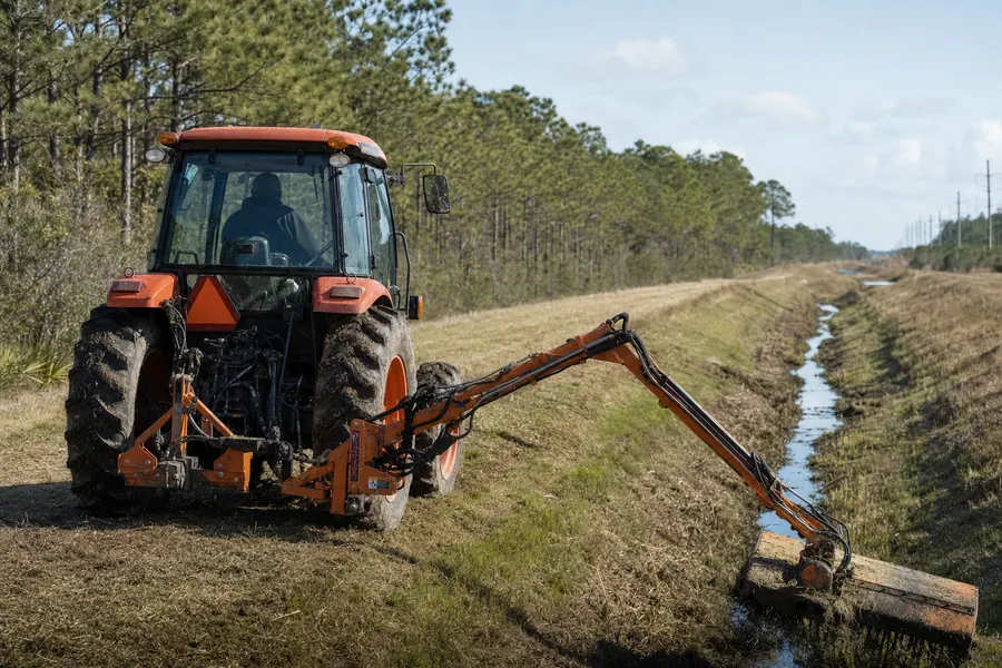Kubota M108S Tractor w/ Alamo Boom Mower in action