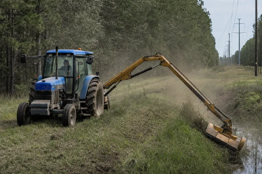 New Holland 6640 Tractor w/ Alamo Boom Mower in action